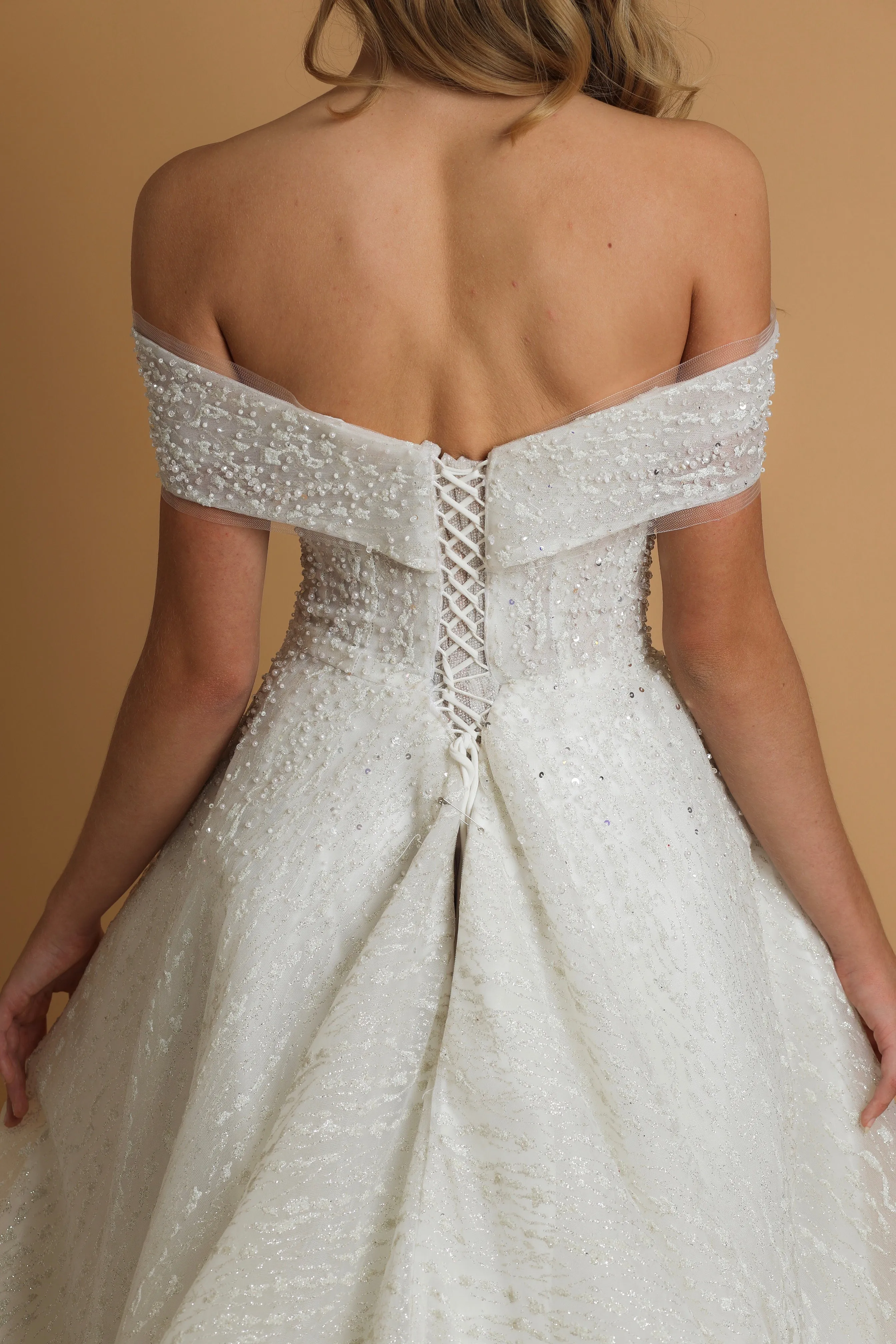 Off the shoulder ballgown wedding dress with a corset back