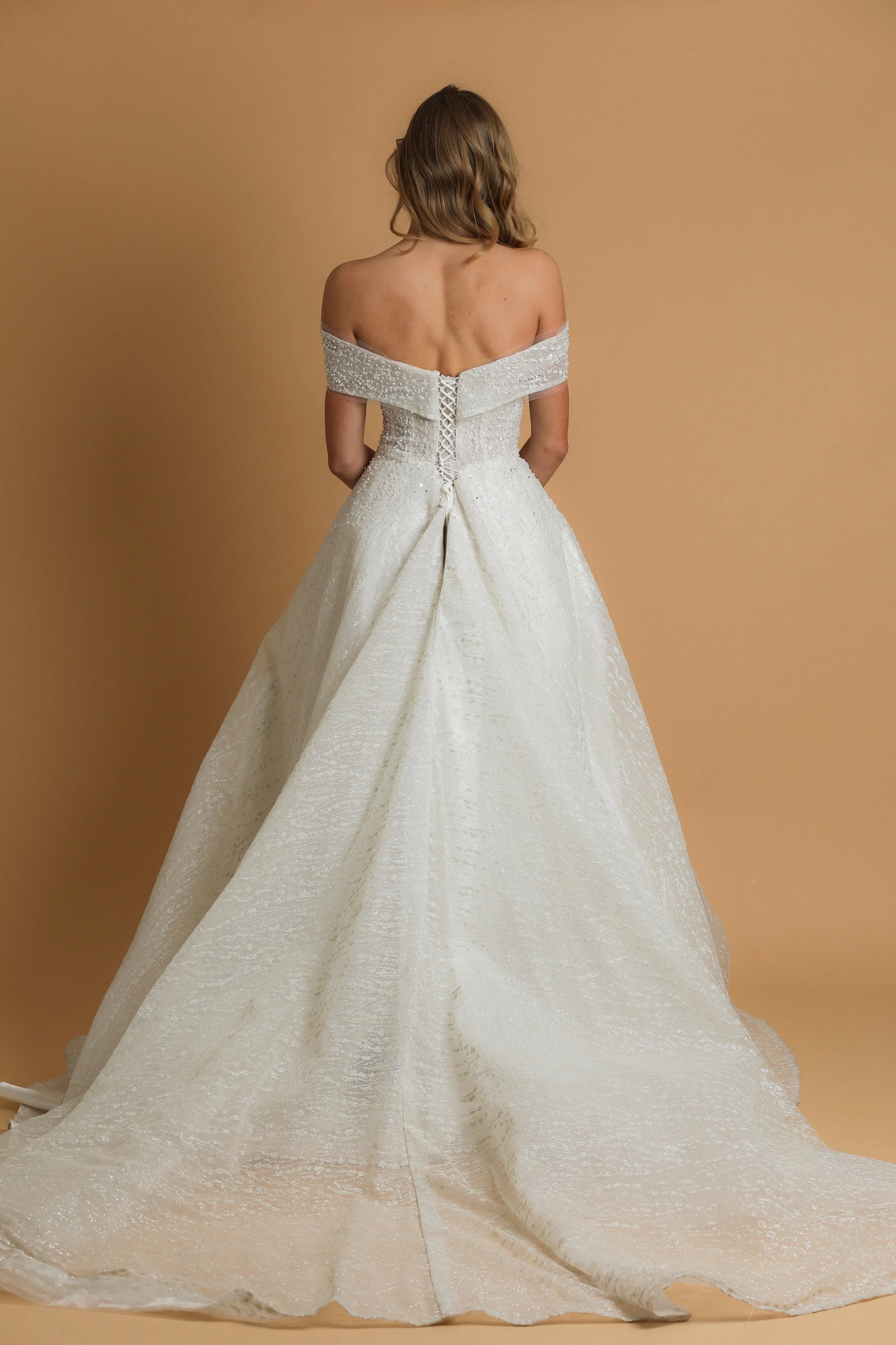 Off the shoulder ballgown wedding dress with a corset back